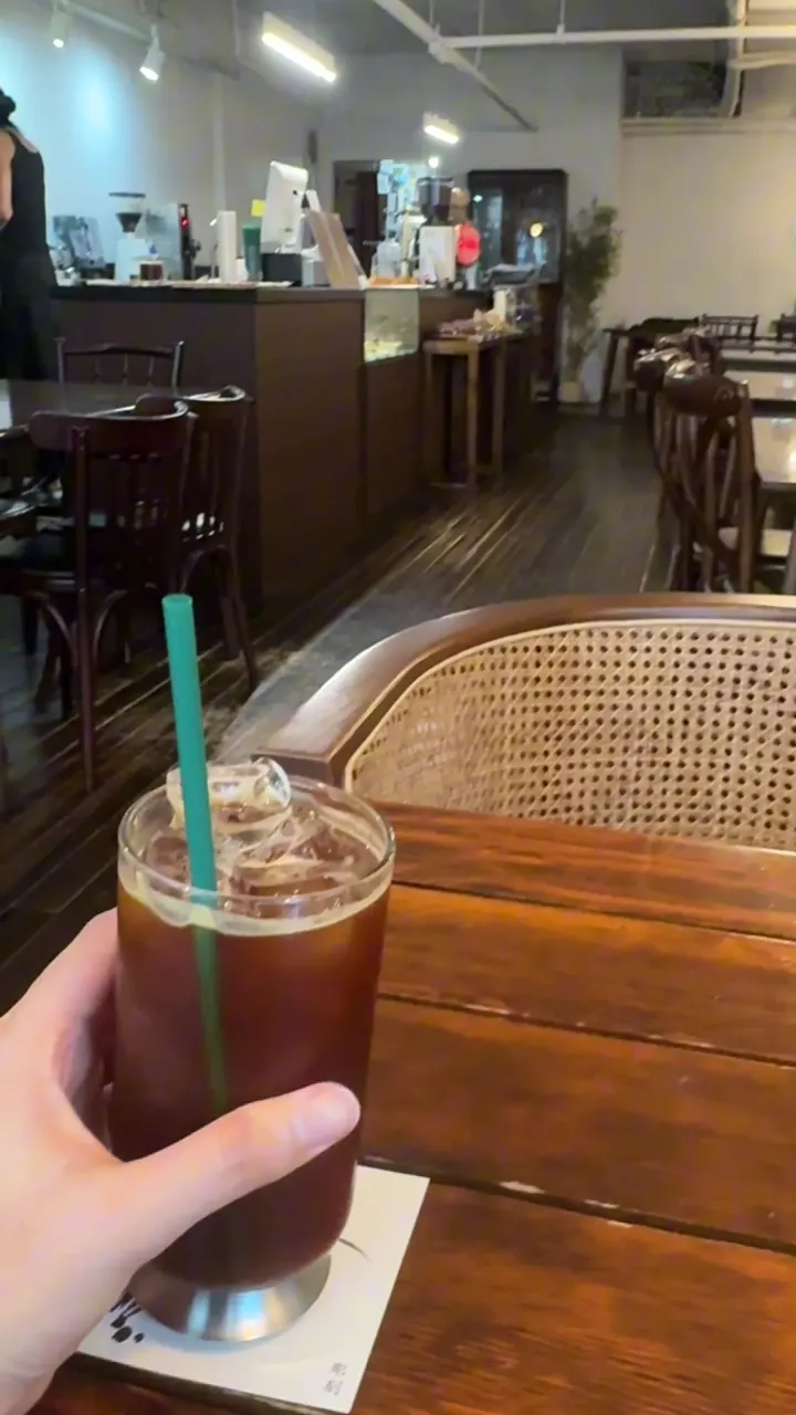 Iced Americano on a wooden table inside Cafe Jogak near Beomgye Station