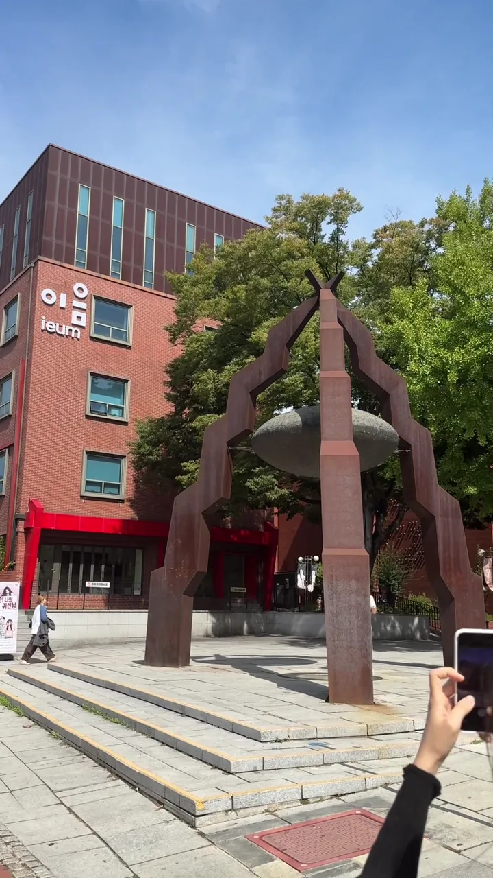 Red-brick arts building and people beside Marronnier Park in Hyehwa